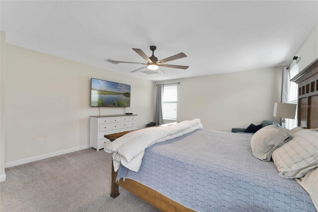 carpeted bedroom with baseboards and ceiling fan