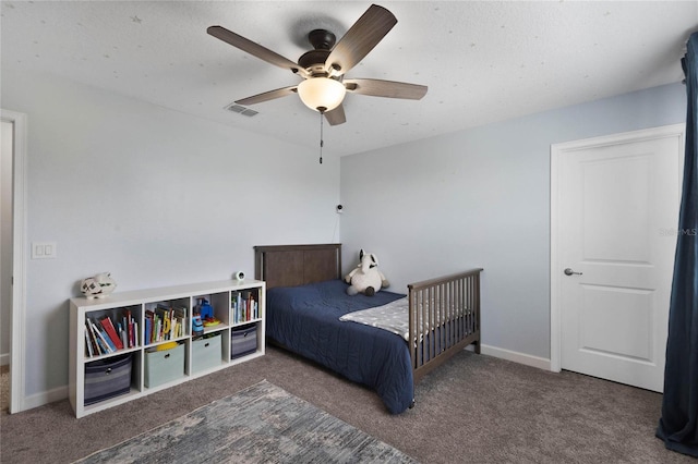 carpeted bedroom with visible vents, baseboards, and a ceiling fan