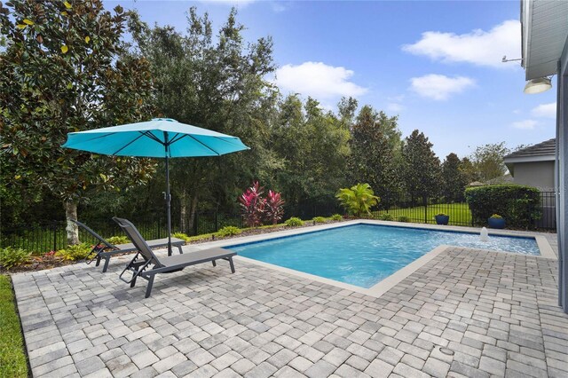 view of swimming pool featuring a patio area, a fenced in pool, and a fenced backyard