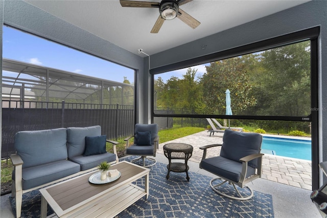 view of patio / terrace with an outdoor living space, a fenced backyard, glass enclosure, a fenced in pool, and ceiling fan