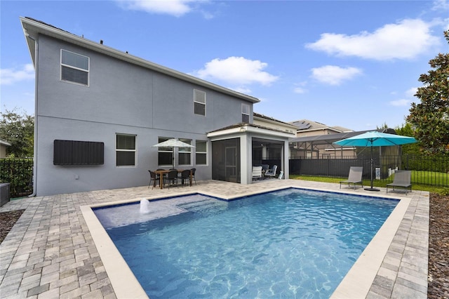 view of pool featuring a fenced in pool, a sunroom, a fenced backyard, and a patio area