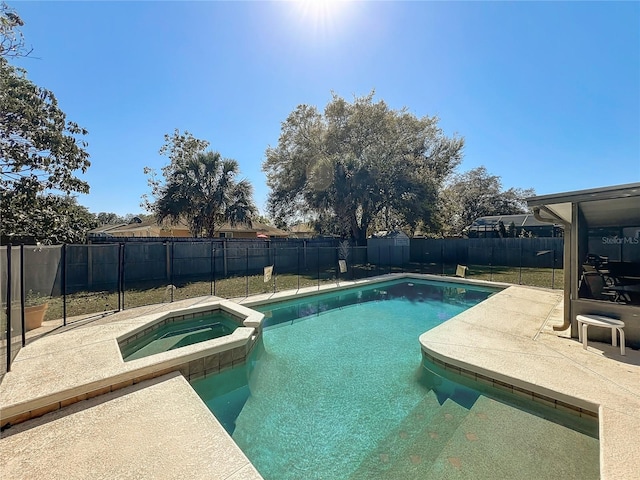 view of swimming pool featuring a patio, a pool with connected hot tub, and a fenced backyard