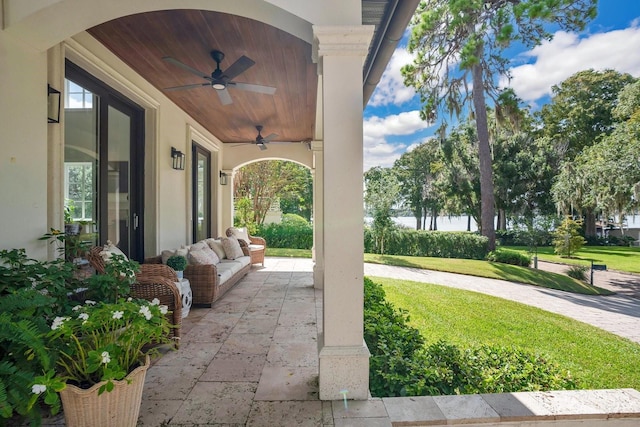 view of patio with outdoor lounge area and a ceiling fan