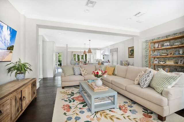 living area featuring recessed lighting, visible vents, dark wood finished floors, and crown molding