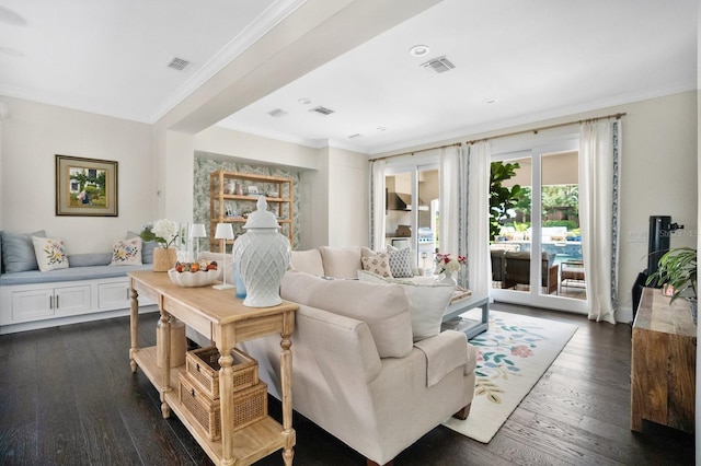 living room with visible vents, dark wood-style floors, and ornamental molding