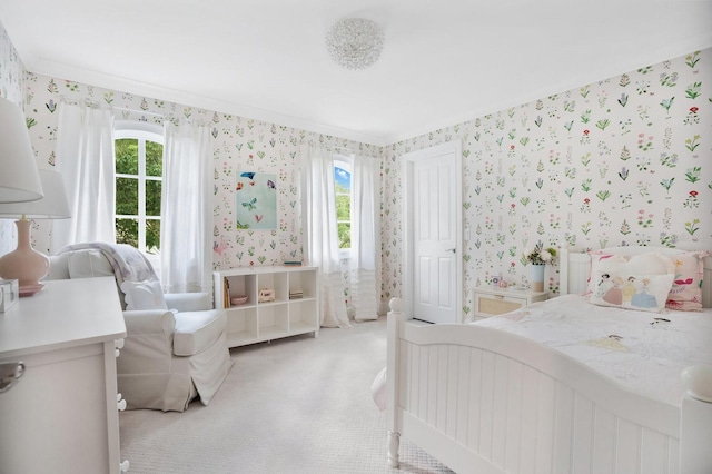 bedroom with light carpet, multiple windows, and wallpapered walls