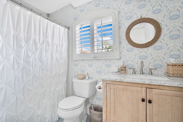 bathroom featuring wallpapered walls, a shower with shower curtain, toilet, and vanity