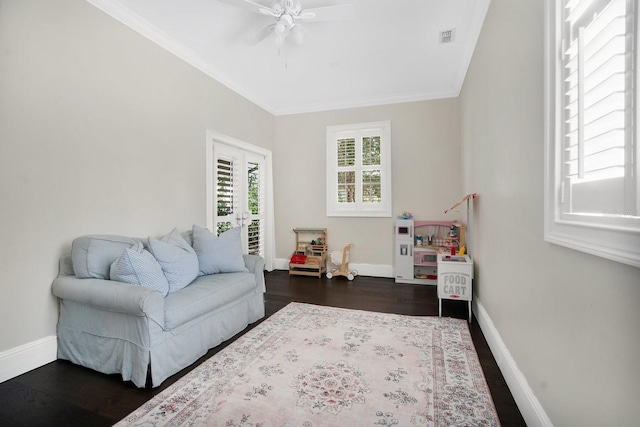 living area with baseboards, visible vents, dark wood-style flooring, and ornamental molding