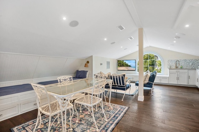 dining space featuring visible vents, dark wood-style floors, wainscoting, and vaulted ceiling