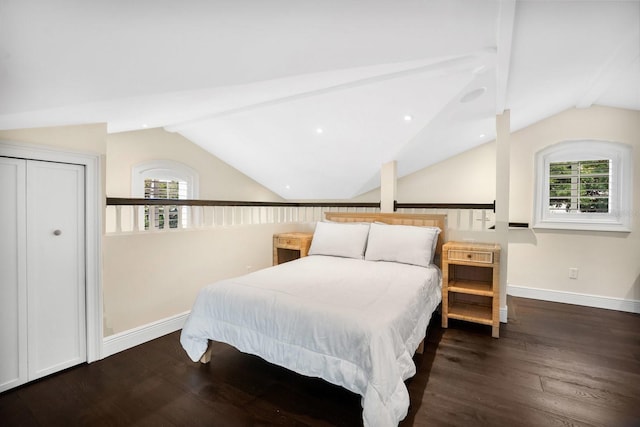 bedroom featuring lofted ceiling with beams, multiple windows, and wood finished floors