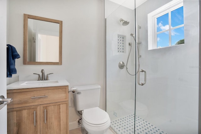 full bathroom with toilet, a stall shower, and vanity