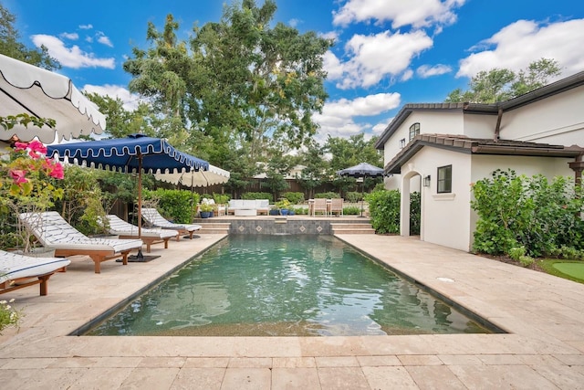 view of swimming pool with a fenced in pool, a patio area, and fence