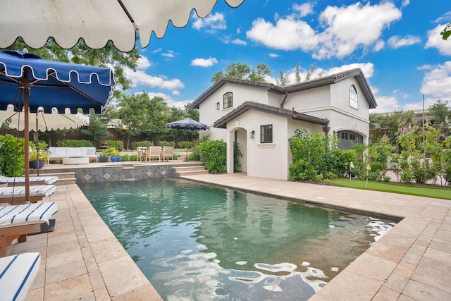 exterior space featuring a patio, fence, a fenced in pool, stucco siding, and an outdoor hangout area