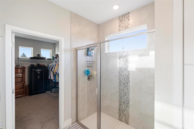 full bath featuring a walk in closet and a shower stall