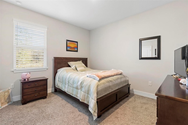 carpeted bedroom with baseboards