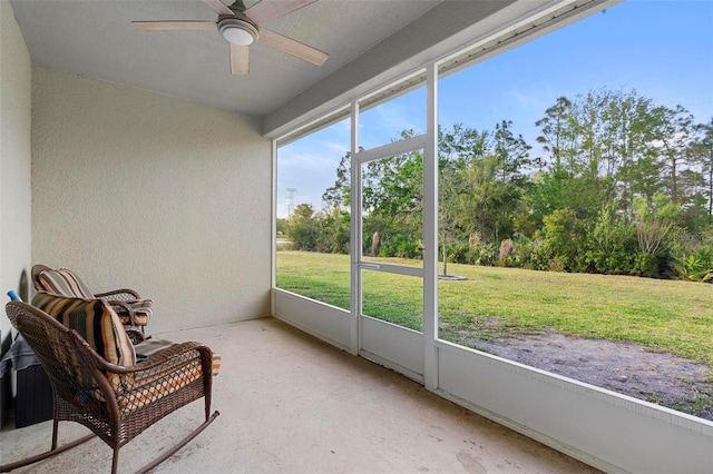 sunroom / solarium featuring plenty of natural light and ceiling fan