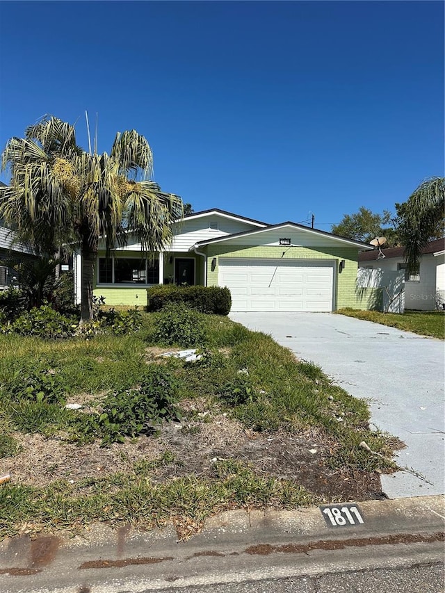 view of front of property featuring a garage and concrete driveway