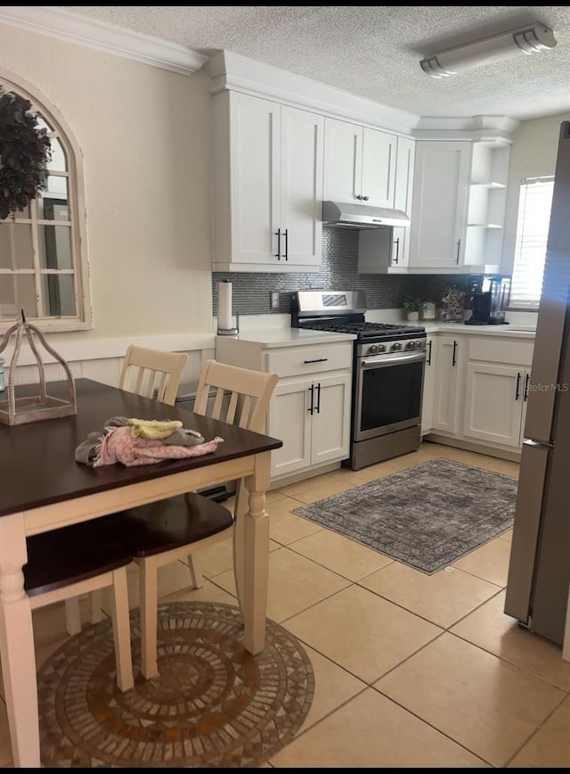 kitchen featuring light tile patterned floors, open shelves, stainless steel appliances, decorative backsplash, and under cabinet range hood