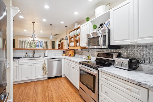 kitchen featuring open shelves, a sink, stainless steel appliances, white cabinets, and light wood-type flooring