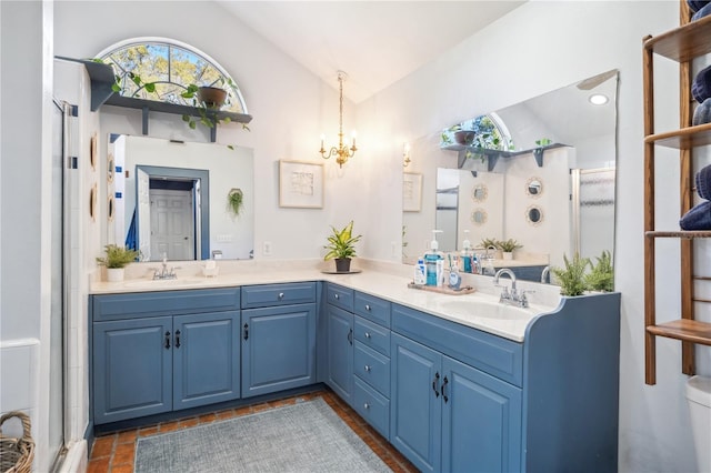 bathroom featuring double vanity, an enclosed shower, lofted ceiling, and a sink