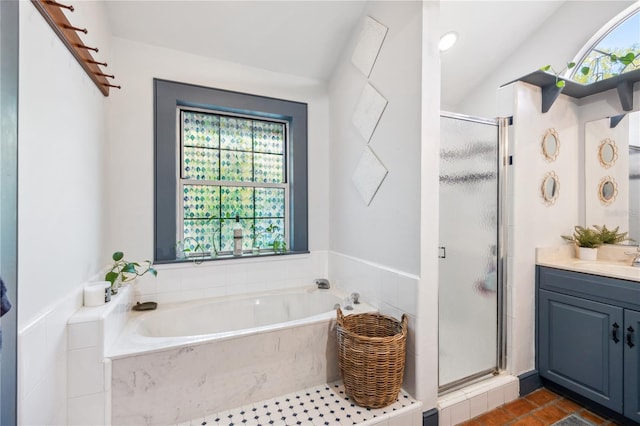 full bath featuring a bath, a stall shower, and vanity