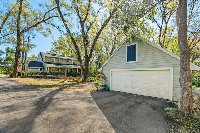 exterior space featuring an outbuilding and a garage