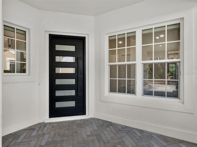 view of exterior entry featuring stucco siding