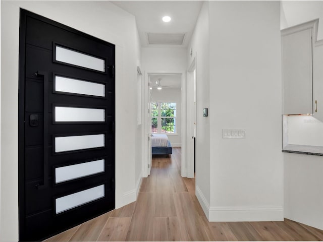 entryway with recessed lighting, light wood-type flooring, and baseboards