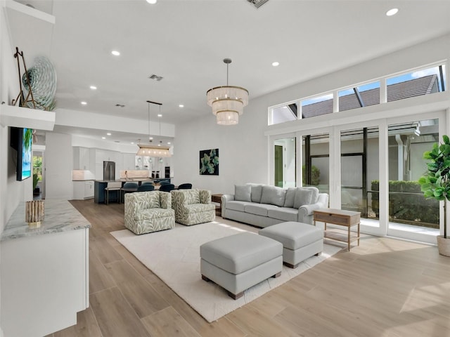 living area featuring a chandelier, visible vents, recessed lighting, and light wood-style floors