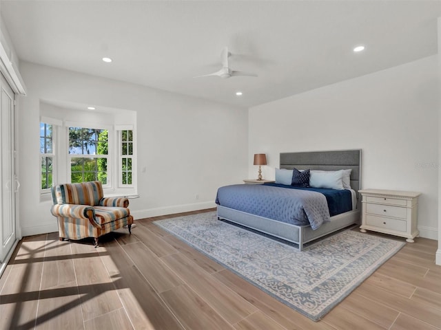 bedroom featuring a ceiling fan, recessed lighting, wood finished floors, and baseboards