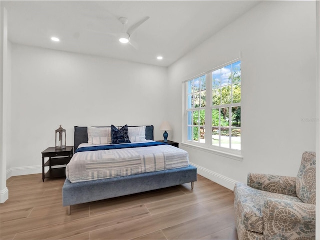 bedroom with recessed lighting, baseboards, and wood finished floors