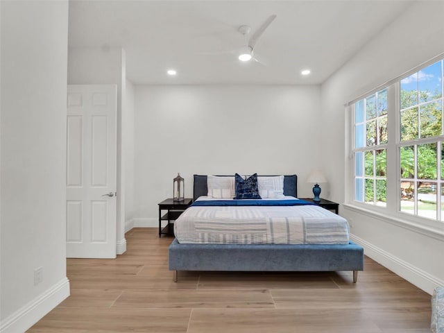 bedroom with recessed lighting, a ceiling fan, light wood-type flooring, and baseboards