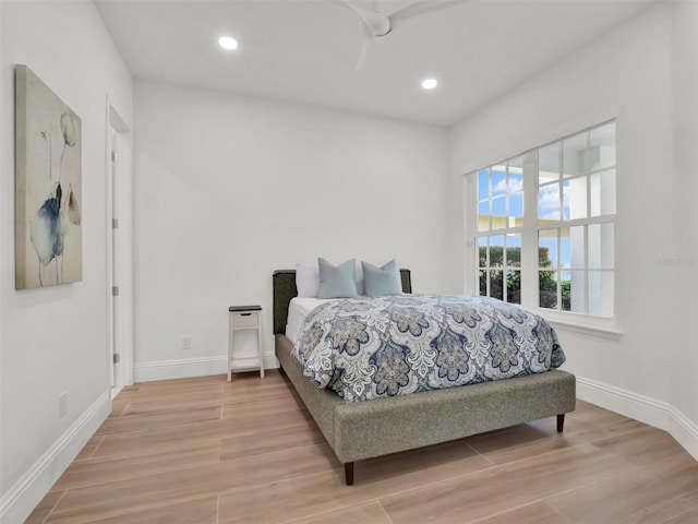 bedroom with recessed lighting, baseboards, and wood finished floors