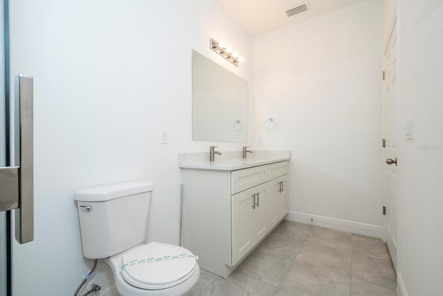 bathroom featuring visible vents, baseboards, toilet, and vanity