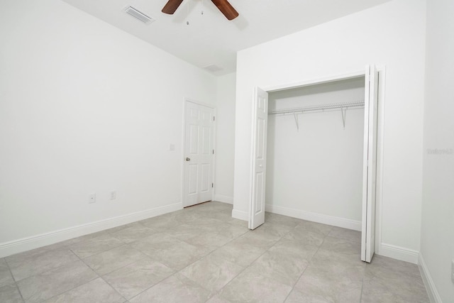 unfurnished bedroom featuring a ceiling fan, visible vents, a closet, and baseboards