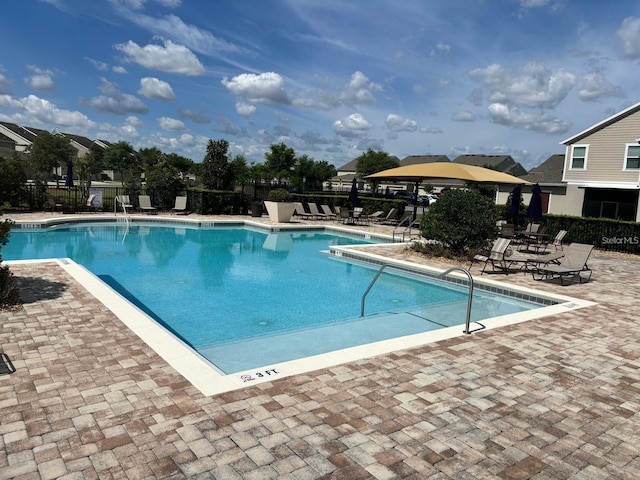 pool featuring a patio and fence