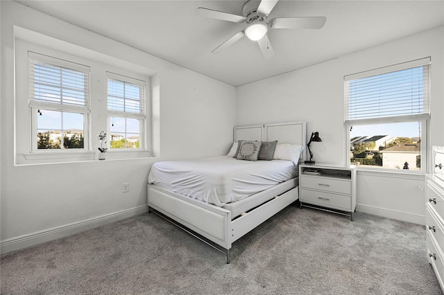 bedroom featuring light carpet, ceiling fan, and baseboards