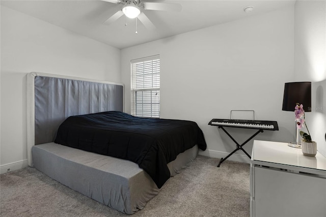 carpeted bedroom with baseboards and a ceiling fan