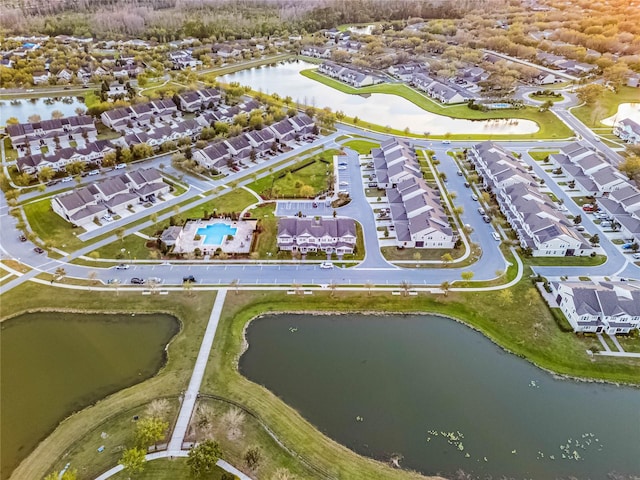 birds eye view of property with a water view and a residential view