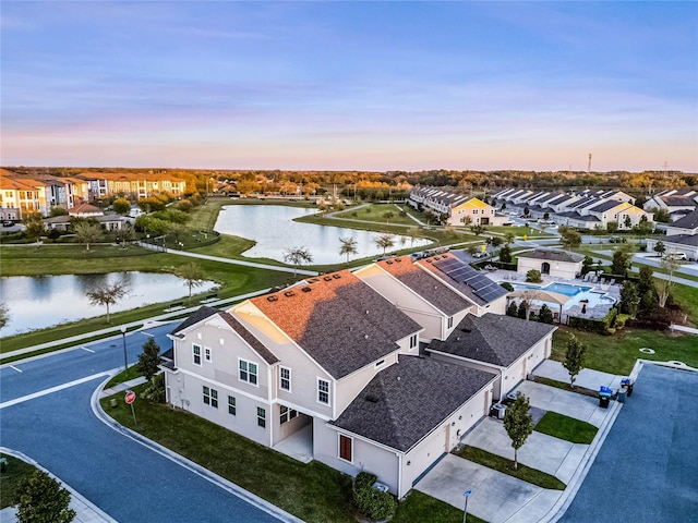 birds eye view of property with a residential view and a water view