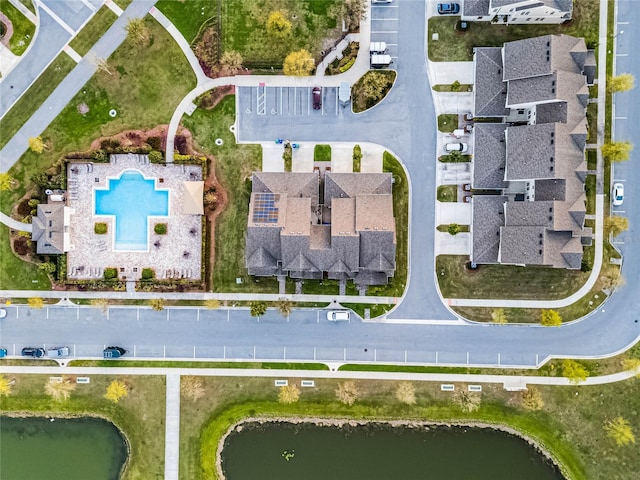 birds eye view of property with a water view