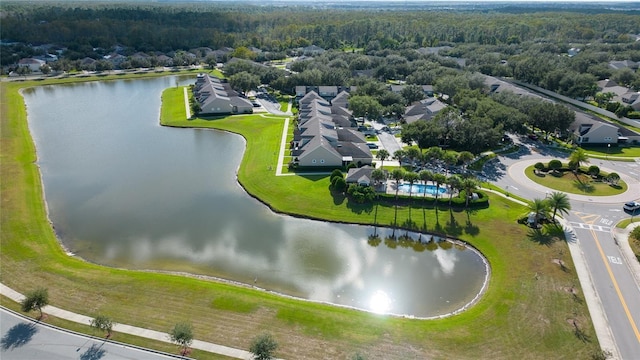 aerial view with a wooded view, a water view, and a residential view