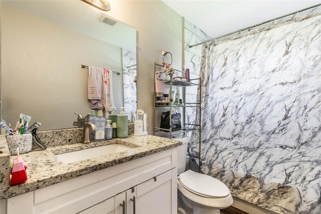 bathroom featuring curtained shower, toilet, vanity, and visible vents