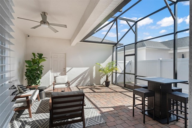 view of patio / terrace with glass enclosure, an outdoor hangout area, and ceiling fan