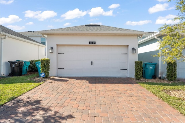 garage with decorative driveway