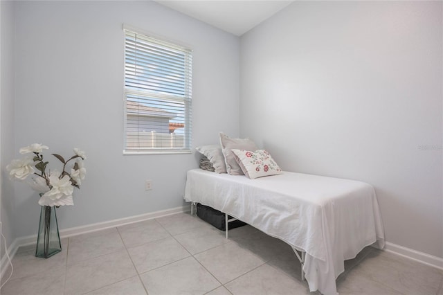 bedroom with baseboards and light tile patterned flooring