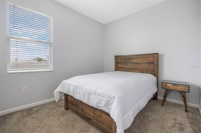 bedroom with carpet flooring and baseboards