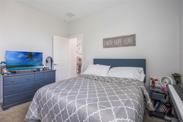 carpeted bedroom featuring visible vents