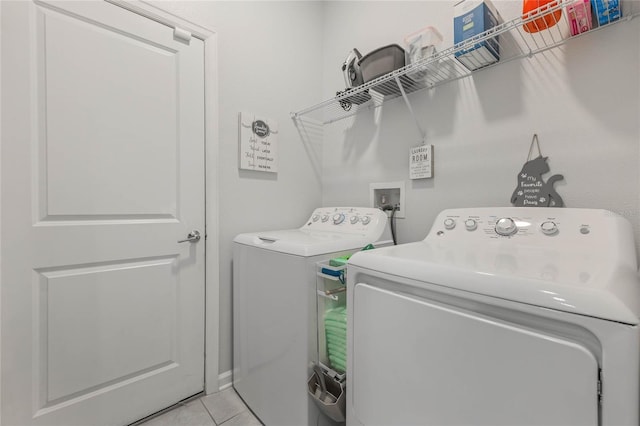 laundry room with light tile patterned floors, laundry area, and washer and dryer