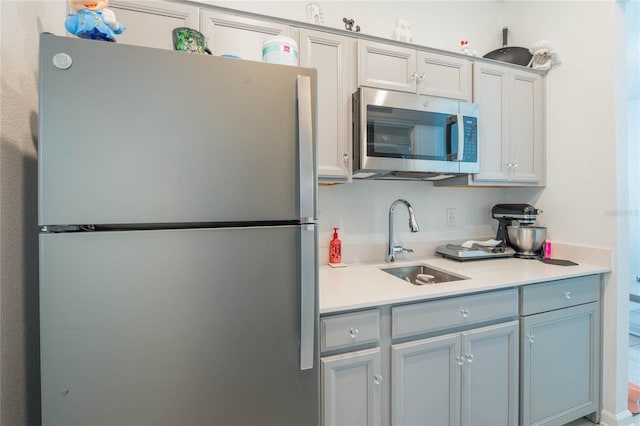 kitchen featuring a sink, light countertops, and stainless steel appliances